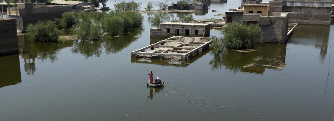 People use a makeshift raft to navigate floodwaters from monsoon rains, in the Dadu district of Sindh Province in Pakistan, on September 9, 2022. (AP Photo/Fareed Khan) People use a makeshift raft to navigate floodwaters from monsoon rains, in the Dadu district of Sindh Province in Pakistan, on September 9, 2022. (AP Photo/Fareed Khan)