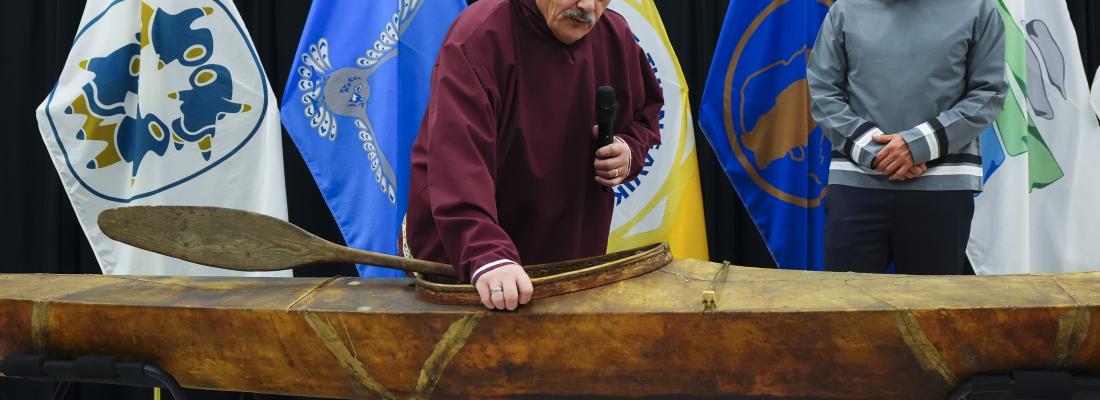 Elder Darrel Nasogaluak (left) and Natan Obed examine a traditional Inuvialuit kayak returned from the Vatican. (Image: Canadian Press/Sean Kilpatrick.)