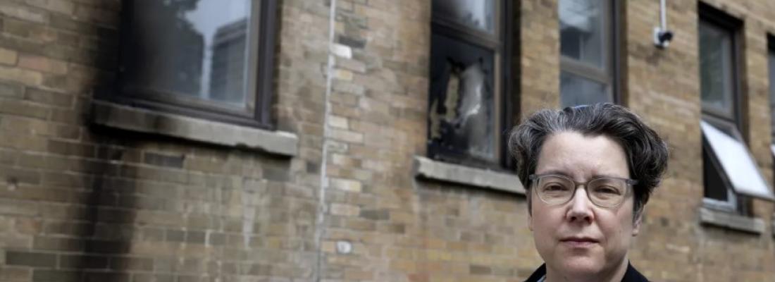 Rabbi Lisa Grushcow stands in front of a Montreal synagogue that was damaged by fire. (Photo via X.)
