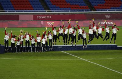 The Canadian women's soccer team celebrates a gold medal victory. 