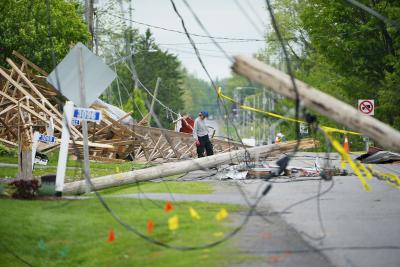 A resident of Hammond, Ontario., cleans up wreckage on May 26, 2022 following a major storm that hit parts of Ontario and Quebec on May 21, 2022. (THE CANADIAN PRESS/Sean Kilpatrick) 