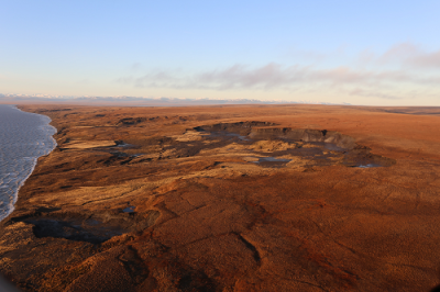 Permafrost thaw along the coast can result in sinkholes and other hazardous landscape conditions. Permafrost thaw along the coast can result in sinkholes and other hazardous landscape conditions.