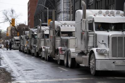 Trucks taking part in the Freedom Convoy are parked on a downtown Ottawa street on January 30, 2022. (THE CANADIAN PRESS/Justin Tang)