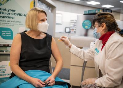 Sylvia Jones, deputy premier of Ontario and minister of health, receives her flu vaccine from pharmacist Zaineb Hassan at a pharmacy in Ottawa on November 25, 2022. (THE CANADIAN PRESS/Ashley Fraser) 