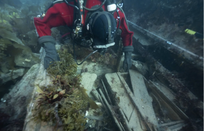 Jonathan Moore, a Parks Canada underwater archaeologist, observes a washing basin and an officer's bedplace on the lower deck of the wreck of the HMS Erebus in September 2022. (Marc-Andre Bernier/Parks Canada via CP)