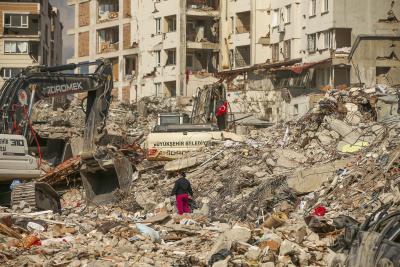 A man walks among debris as excavators demolish the remains of a destroyed building following the earthquake in Samandag, southern Turkey, on February 22, 2023. (AP Photo/Emrah Gurel) A man walks among debris as excavators demolish the remains of a destroyed building following the earthquake in Samandag, southern Turkey, on February 22, 2023. (AP Photo/Emrah Gurel)