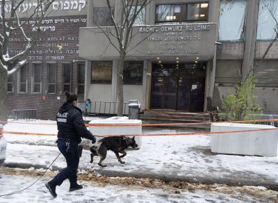 Police in Montreal search for clues outside Yeshiva Gedola school after it was hit by gunfire. (THE CANADIAN PRESS/Ryan Remiorz)