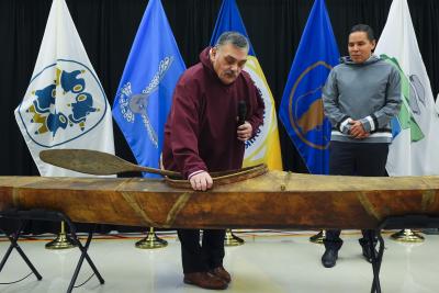 Elder Darrel Nasogaluak (left) and Natan Obed examine a traditional Inuvialuit kayak returned from the Vatican. (Image: Canadian Press/Sean Kilpatrick.)