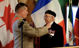 Joseph Novak receiving his award from General Benoît Puga at the Whitehorse legion on October 20. 