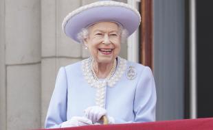 Queen Elizabeth II smiles from the balcony of Buckingham Palace on June 2, 2022, on the first of four days of celebrations to mark the Platinum Jubilee celebrating the monarch’s 70 years of service. (Jonathan Brady/Pool Photo via AP) 