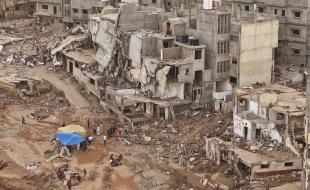 Rescuers and relatives of victims set up tents in front of collapsed buildings in Derna, Libya, on September 18, 2023. (AP Photo/Muhammad J. Elalwany, File)