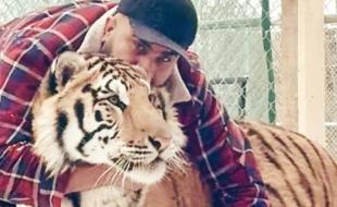 Zohaib Masood with one of the tigers he kept on his property.