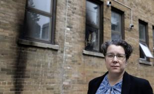 Rabbi Lisa Grushcow stands in front of a Montreal synagogue that was damaged by fire. (Photo via X.)